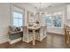 Bright dining area featuring a wooden table, upholstered chairs, and a built-in bench with views from many windows at 303 S Ladd Ct, Charleston, SC 29492