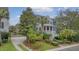 Charming home exterior with a welcoming front porch, well-manicured landscaping, and a driveway at 303 S Ladd Ct, Charleston, SC 29492