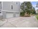 Attached two-car garage with a spacious driveway and well-maintained landscaping, providing convenient parking at 303 S Ladd Ct, Charleston, SC 29492
