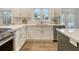 Bright kitchen with white cabinets, stainless steel appliances, quartz countertops, and hardwood flooring at 303 S Ladd Ct, Charleston, SC 29492
