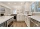 Bright kitchen featuring white cabinets, stainless steel appliances, and a marble countertop at 303 S Ladd Ct, Charleston, SC 29492