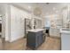 Open concept kitchen with stainless steel refrigerator, kitchen island, and gas range stove and oven appliance at 303 S Ladd Ct, Charleston, SC 29492