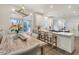 Spacious kitchen and dining area with island, bar stools, and large windows offering natural light and views at 303 S Ladd Ct, Charleston, SC 29492