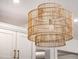 Unique wicker pendant light fixture adds a warm, natural touch to the kitchen's modern design at 303 S Ladd Ct, Charleston, SC 29492