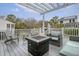 Inviting outdoor patio with a pergola, string lights, comfortable seating, and a cozy fire pit at 303 S Ladd Ct, Charleston, SC 29492