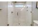 Detailed view of the bathroom showcasing the glass-enclosed shower with white subway tiles and a small window at 303 S Ladd Ct, Charleston, SC 29492