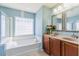 Bathroom with a soaking tub, tile floors, and double vanity with flower arrangement at 309 Peters Creek Dr, Summerville, SC 29486