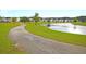 Scenic view of a community pond, walking path, and neighborhood homes, perfect for leisurely strolls and enjoying nature at 309 Peters Creek Dr, Summerville, SC 29486