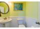 Charming powder room with wainscoting, decorative mirror, and stylish fixtures at 309 Peters Creek Dr, Summerville, SC 29486