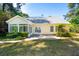 Back exterior featuring a sunroom, a patio, and manicured landscaping, perfect for outdoor entertaining at 328 Fern House Walk, Mount Pleasant, SC 29464