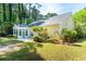 Back exterior view of the property featuring a sunroom, patio, and well-maintained landscaping at 328 Fern House Walk, Mount Pleasant, SC 29464