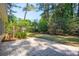 Spacious backyard featuring a lush lawn, mature trees, and a brick patio at 328 Fern House Walk, Mount Pleasant, SC 29464