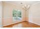 Charming dining room featuring hardwood floors, wainscoting, and a decorative chandelier at 328 Fern House Walk, Mount Pleasant, SC 29464