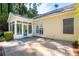 Exterior view of a bright home featuring a sunroom and brick patio at 328 Fern House Walk, Mount Pleasant, SC 29464