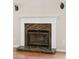 The marble fireplace features glass doors, flanked by sconces, and a mantle at 328 Fern House Walk, Mount Pleasant, SC 29464