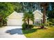 Charming single-story home features a manicured lawn and mature trees, offering serene curb appeal at 328 Fern House Walk, Mount Pleasant, SC 29464