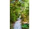 Charming stone pathway surrounded by lush foliage, leading to a serene and private retreat at 328 Fern House Walk, Mount Pleasant, SC 29464