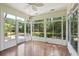 Relaxing sunroom features many windows and hardwood floors with views of the backyard at 328 Fern House Walk, Mount Pleasant, SC 29464