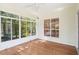 Bright sunroom with hardwood floors, floor-to-ceiling windows, and a ceiling fan at 328 Fern House Walk, Mount Pleasant, SC 29464