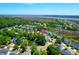 The aerial view displays the property's setting within a waterfront community and lush surroundings at 352 Clayton Dr, Charleston, SC 29414