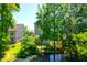 A view of the backyard with lush trees, backing onto a tranquil pond at 352 Clayton Dr, Charleston, SC 29414