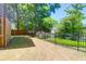 The backyard features a well-maintained lawn, a privacy fence, and a view of the pond at 352 Clayton Dr, Charleston, SC 29414