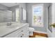 Bright bathroom featuring a white vanity, window, and shower with glass door, offering a clean and modern look at 352 Clayton Dr, Charleston, SC 29414