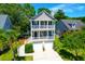 The home has a charming multi-level facade with decks, a well-maintained yard, and a two-car garage at 352 Clayton Dr, Charleston, SC 29414
