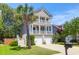 Charming two-story home featuring double balconies, a well-manicured lawn and a lovely palm tree at 352 Clayton Dr, Charleston, SC 29414