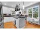 Bright kitchen with white cabinets, a dark stone countertop island and stainless steel appliances at 352 Clayton Dr, Charleston, SC 29414