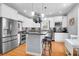 Bright kitchen featuring white cabinets, black countertops, a pot rack, and stainless steel appliances at 352 Clayton Dr, Charleston, SC 29414
