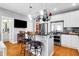 Charming eat-in kitchen featuring granite countertops and a modern pot rack hanging over the kitchen island at 352 Clayton Dr, Charleston, SC 29414