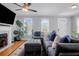 Inviting living room with gray sofa and ottoman, fireplace with mounted TV and bright windows at 352 Clayton Dr, Charleston, SC 29414