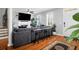 Open living room with hardwood floors, sofa with stools, fireplace and mounted TV at 352 Clayton Dr, Charleston, SC 29414