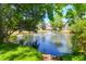 Scenic view of a neighborhood pond with a fountain, surrounded by lush greenery and trees at 352 Clayton Dr, Charleston, SC 29414