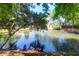 The pond is surrounded by lush greenery, mature trees, and a beautiful fountain feature at 352 Clayton Dr, Charleston, SC 29414