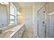 Bathroom with a large vanity, double sinks, and a glass enclosed tile shower at 366 Trailmore Ln, Summerville, SC 29486