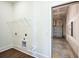 Laundry room with washer-dryer hookups and wire shelving, and a view into the garage at 366 Trailmore Ln, Summerville, SC 29486