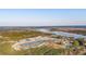 An aerial view showcases the community nestled amidst lush greenery, forests, and a serene lake at 3894 Summerton St, Mount Pleasant, SC 29466