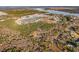 An aerial view showcases the community nestled amidst lush greenery, forests, and a serene lake at 3894 Summerton St, Mount Pleasant, SC 29466