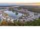 Aerial view of a neighborhood surrounding a beautiful lake with houses nestled among lush green trees at 3894 Summerton St, Mount Pleasant, SC 29466