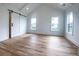 Bright bedroom with high ceiling, sliding barn door, hardwood floors, and natural light at 3894 Summerton St, Mount Pleasant, SC 29466
