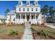 Charming two-story home showcasing a welcoming front porch and manicured lawn on a sunny day at 3894 Summerton St, Mount Pleasant, SC 29466