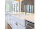Close up view of kitchen island with white farmhouse sink and modern faucet; bright and inviting space at 3894 Summerton St, Mount Pleasant, SC 29466