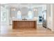 Bright, modern kitchen with a wooden center island, stainless steel refrigerator, and sleek white cabinets at 3894 Summerton St, Mount Pleasant, SC 29466