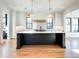 Well-lit kitchen features an island with seating, white cabinets, and pendant lighting for a modern touch at 3894 Summerton St, Mount Pleasant, SC 29466