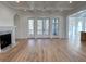 Spacious living room with a fireplace, coffered ceiling, and access to an outdoor balcony at 3894 Summerton St, Mount Pleasant, SC 29466