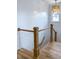 Bright stairwell features white shiplap walls, oak stairs, and a statement chandelier for a touch of elegance at 3894 Summerton St, Mount Pleasant, SC 29466