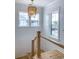Bright stairwell features white shiplap walls, oak stairs, and a statement chandelier for a touch of elegance at 3894 Summerton St, Mount Pleasant, SC 29466
