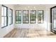 Sunroom with a wall of windows, hardwood floors, and modern lighting, perfect for relaxing and enjoying nature at 3894 Summerton St, Mount Pleasant, SC 29466